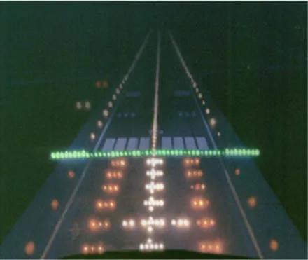 A runway at night seen from the approach, its centre line and threshold picked out in green and amber lights.