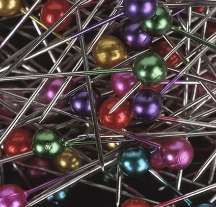 A tightly packed mass of coloured metal pin heads, seen close up.
